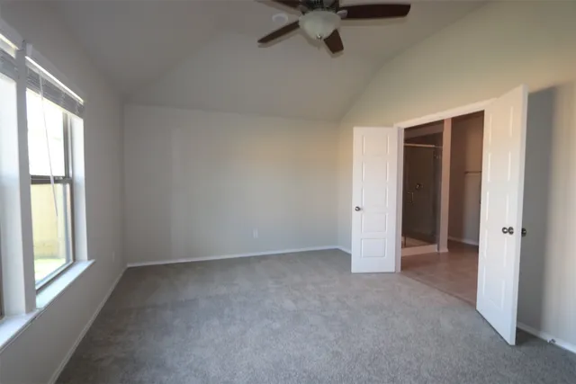 an empty room with a empty space and windows