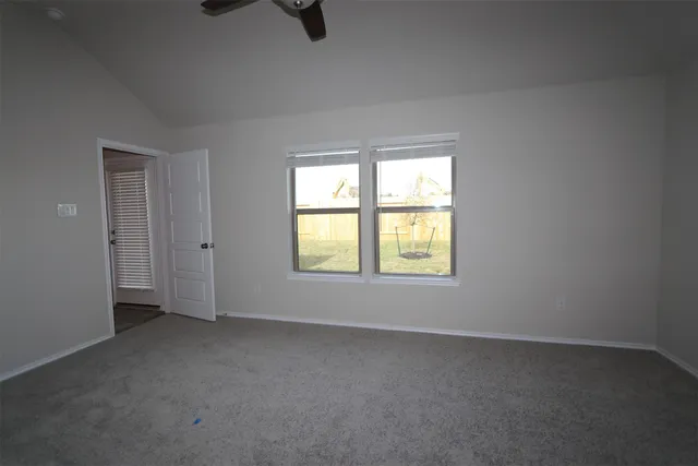 an empty room with a empty space and windows