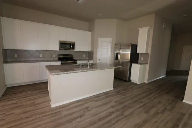 a bathroom with a granite countertop toilet and a shower