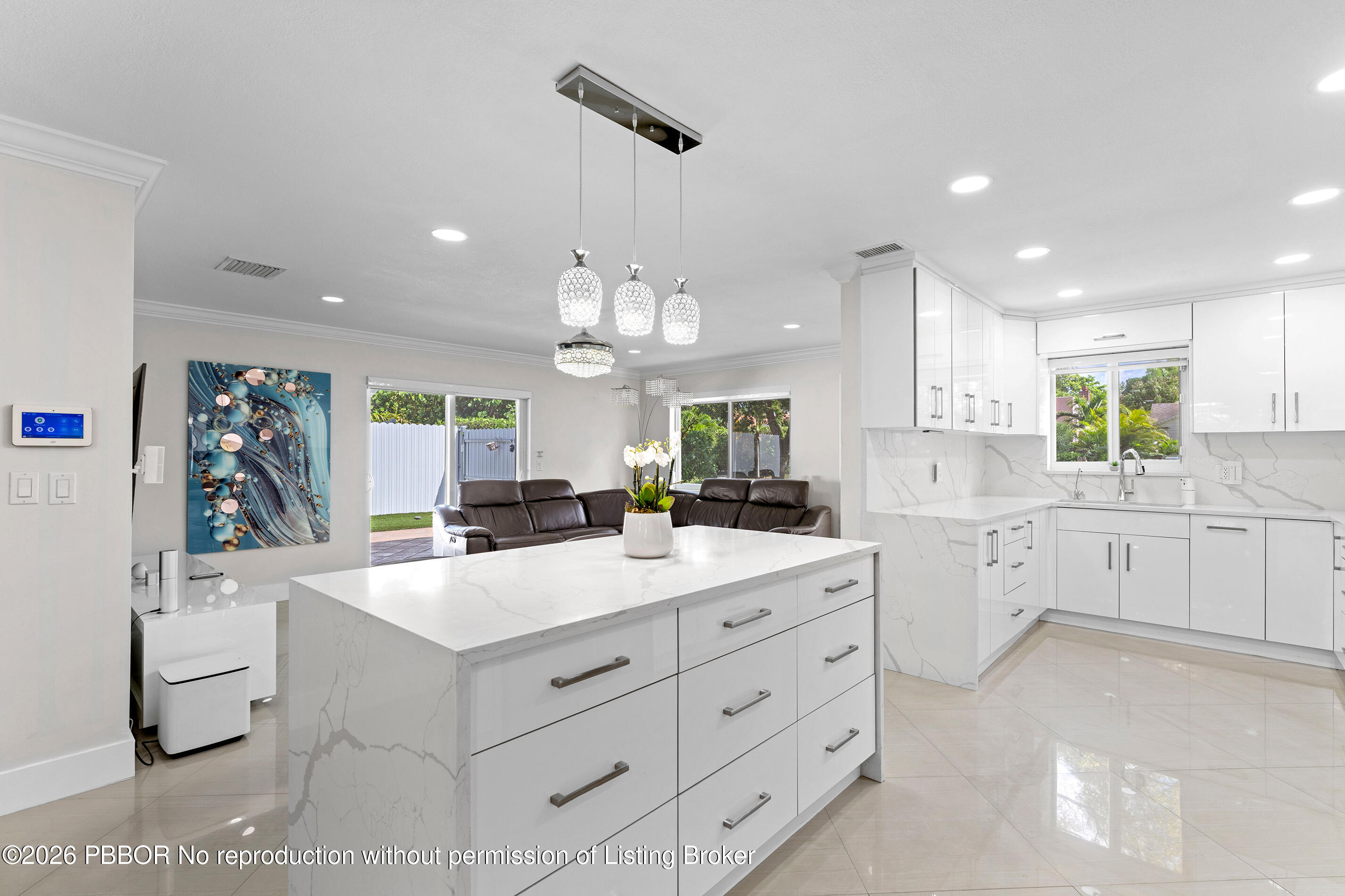 747 Avon Road West Palm Beach, FL 33401 - Photo 28 of 29 a large white kitchen with cabinets