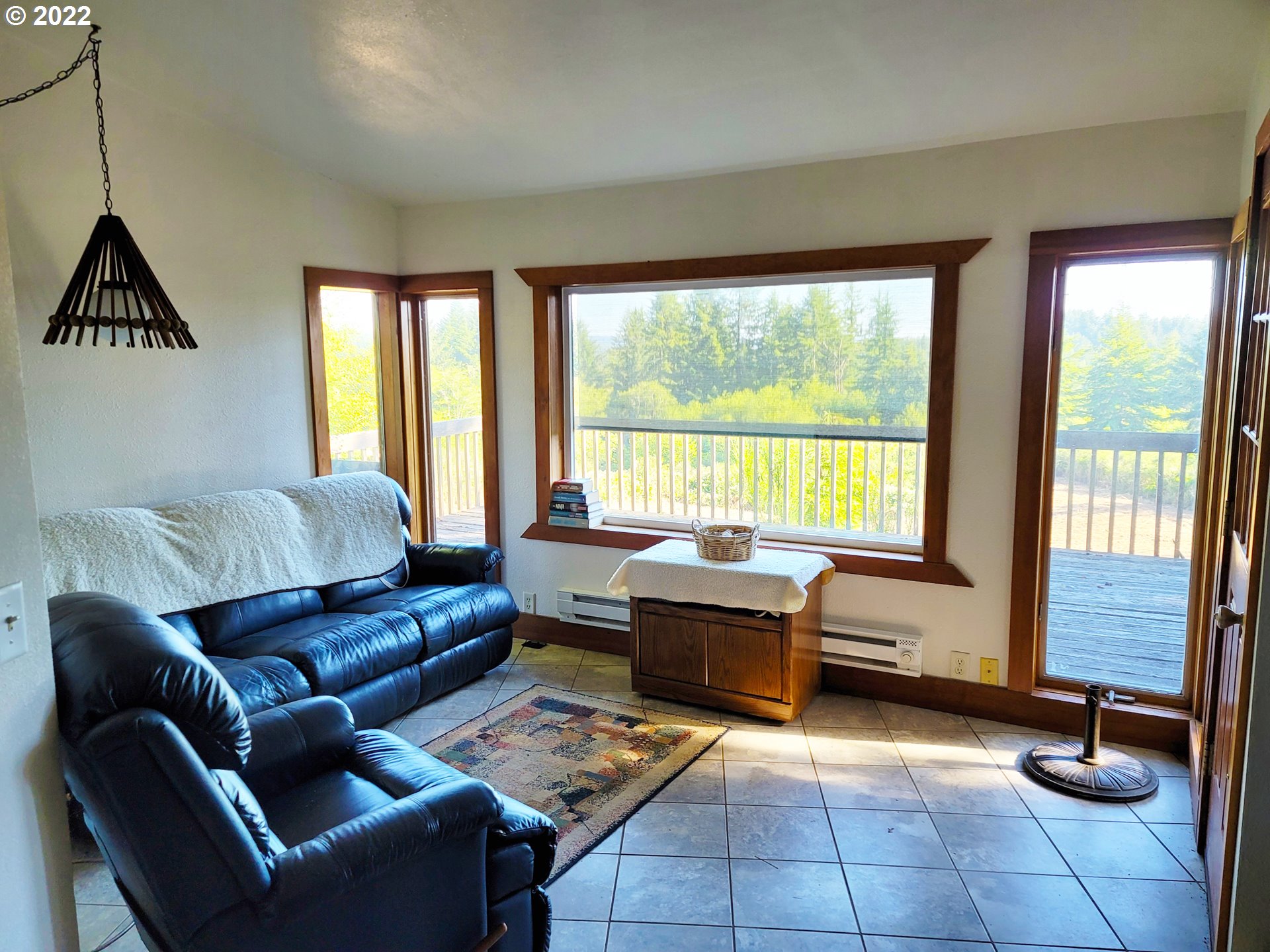 5529 Herman Cape Road Florence, OR 97439 - Photo 3 of 17 a living room with furniture and a floor to ceiling window
