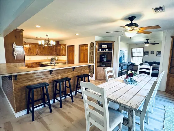 a dining table with chairs and wooden floor