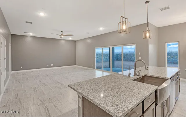 a spacious bathroom with a granite countertop sink and mirror