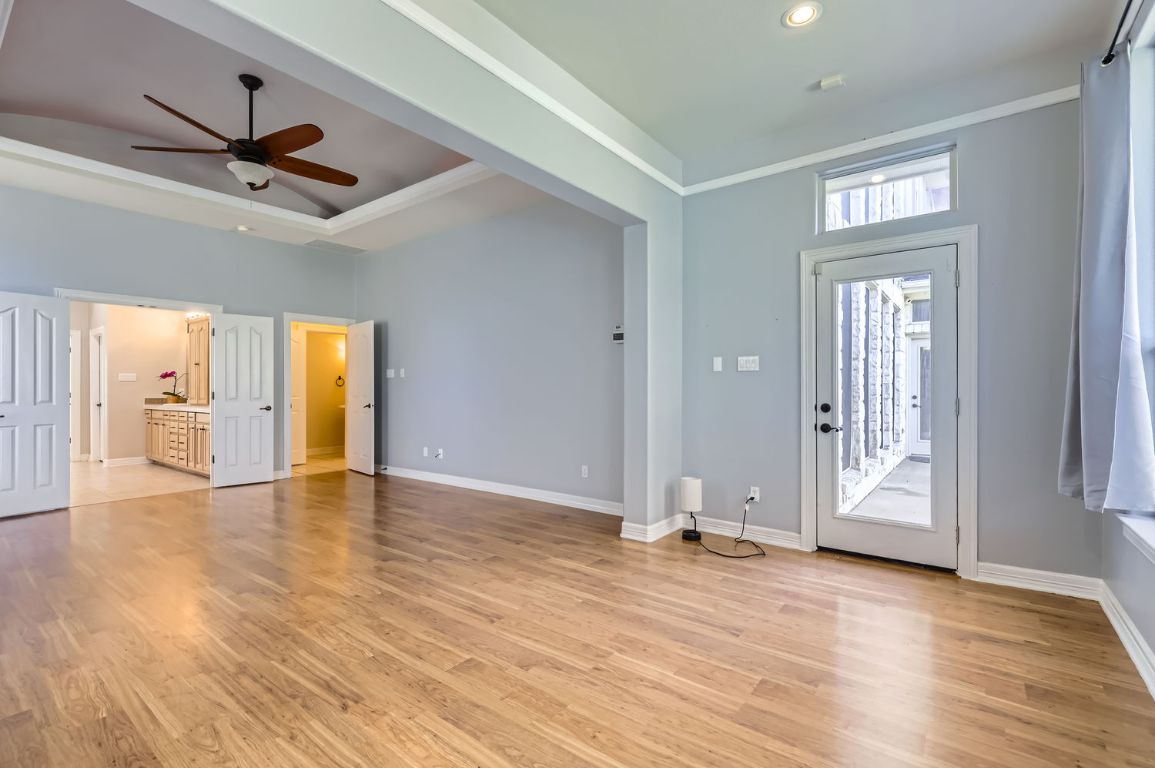 210 Amandas Way Leander, TX 78641 - Photo 17 of 38 Foyer entrance with light wood-type flooring, a raised ceiling, ceiling fan, and baseboards
