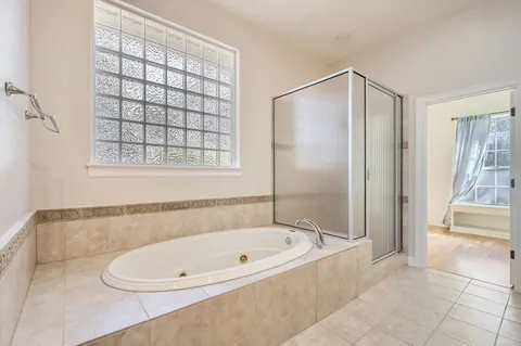 a bathroom with a bathtub and a shower