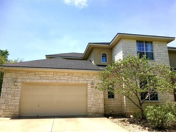 a front view of a house with trees