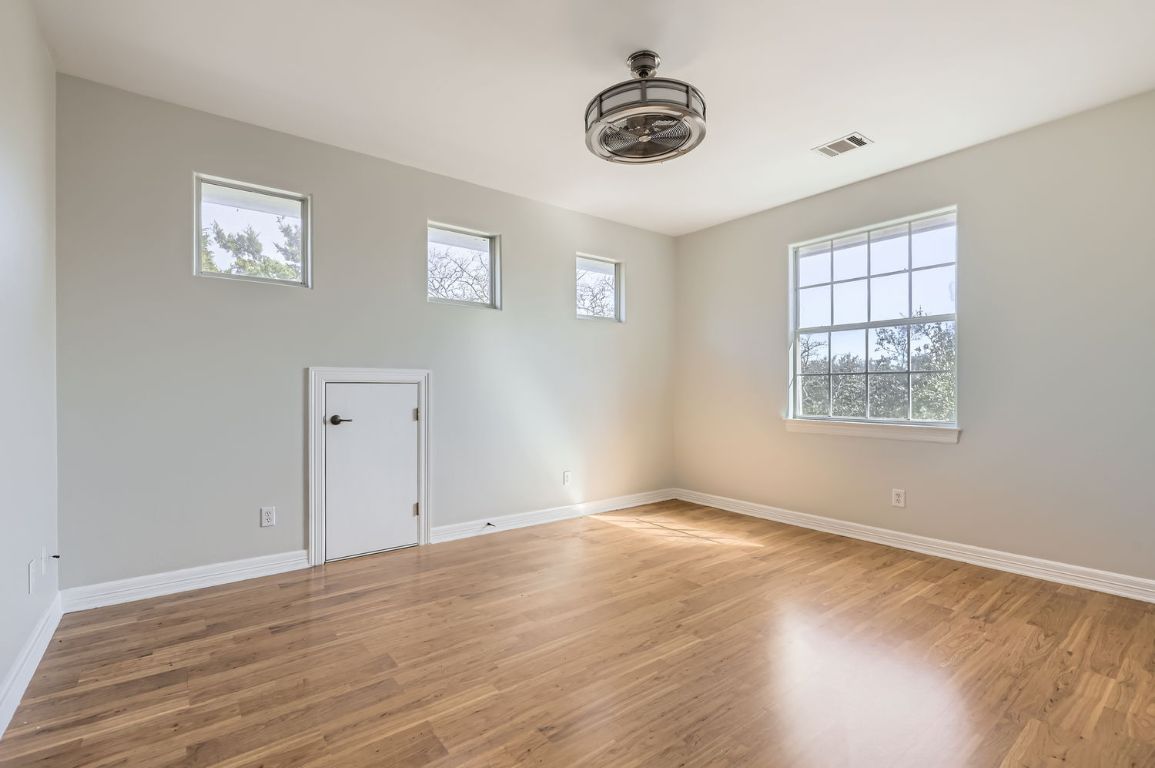 210 Amandas Way Leander, TX 78641 - Photo 26 of 38 Empty room featuring light wood-type flooring, baseboards, visible vents, and ceiling fan