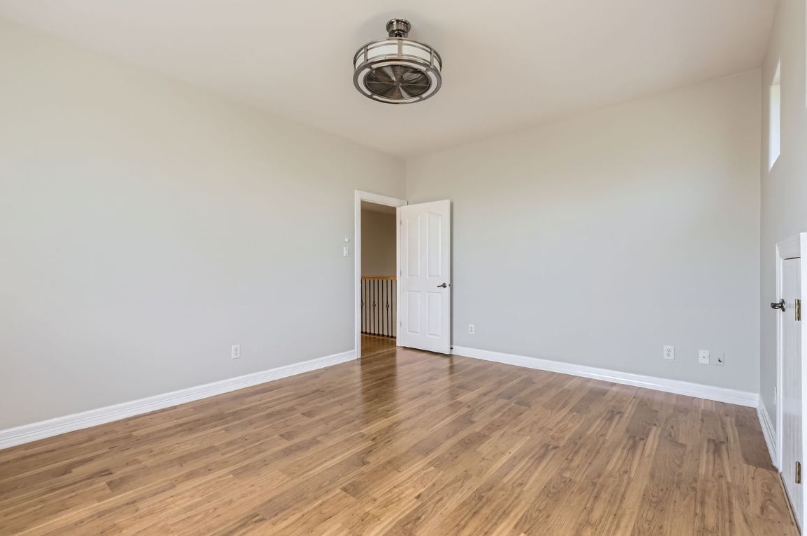 210 Amandas Way Leander, TX 78641 - Photo 27 of 38 Unfurnished bedroom with light wood-style flooring and baseboards