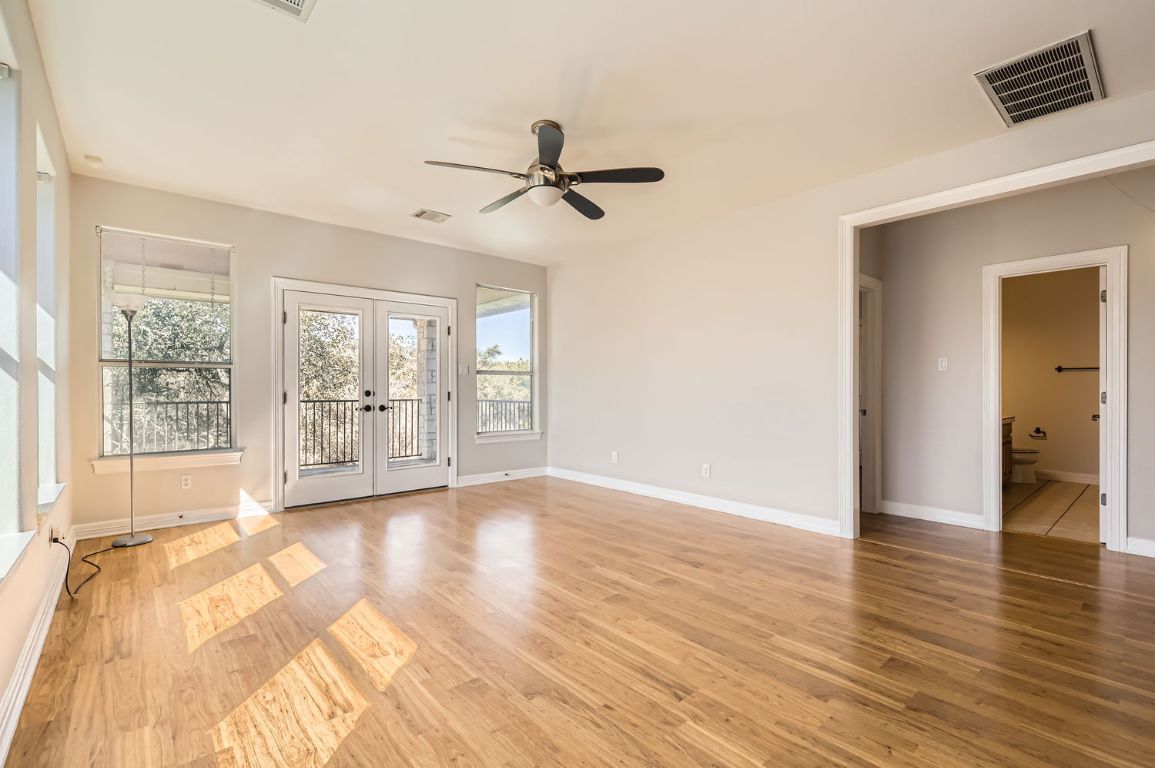 210 Amandas Way Leander, TX 78641 - Photo 29 of 38 Unfurnished room with light wood-style floors, baseboards, visible vents, and french doors