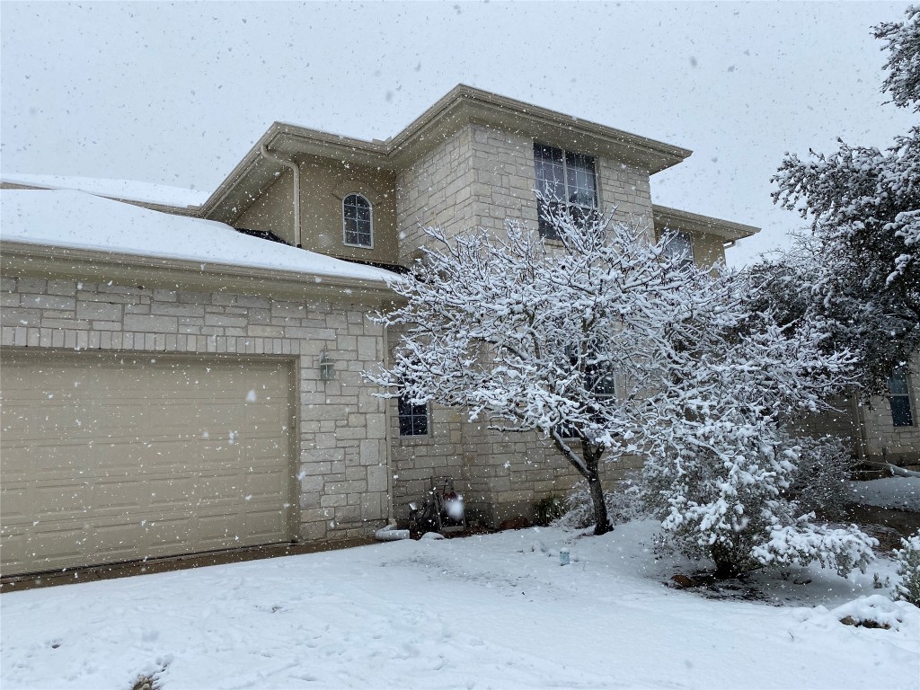 210 Amandas Way Leander, TX 78641 - Photo 35 of 38 View of snow covered exterior with a garage and stone siding