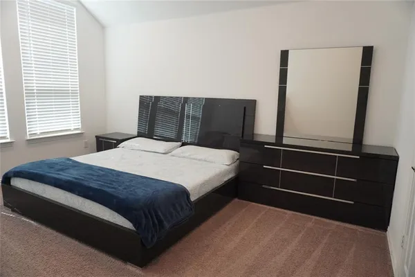 a bedroom with a bed and window