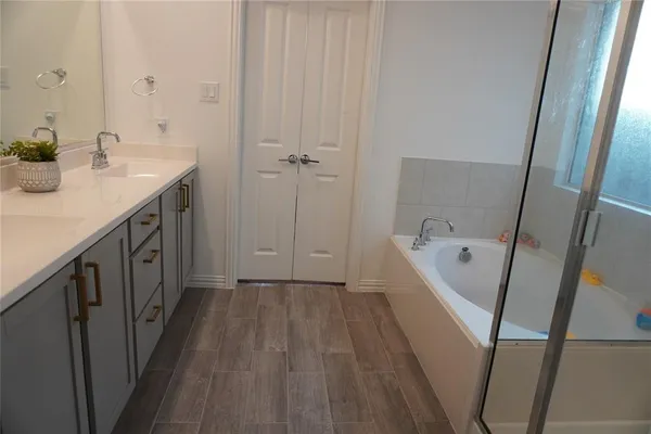 a bathroom with double vanity sinks and a mirror
