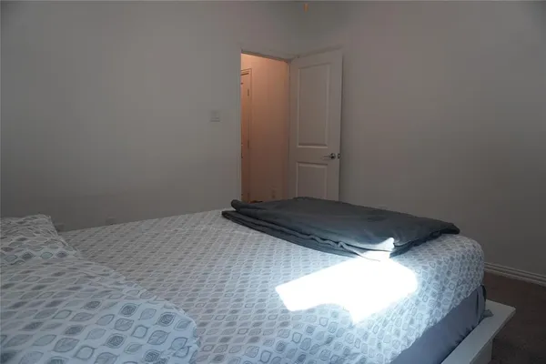 a bedroom with a bed and cabinet