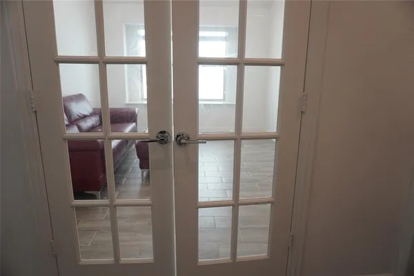 a blue couch sitting in a living room with a rug