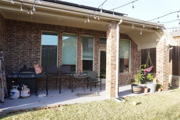 a view of a backyard with plants and outdoor seating