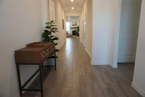 a hallway with wooden floor and furniture