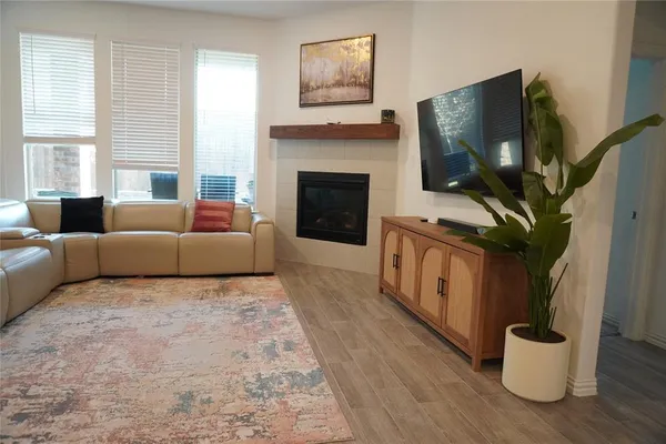 a living room with furniture a flat screen tv and a fireplace