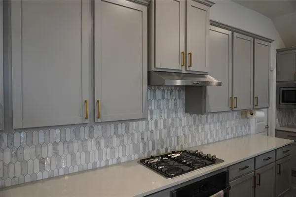 a kitchen with granite countertop a stove and a sink