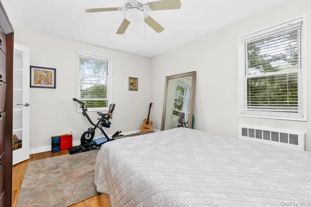a view of a bedroom with furniture and windows