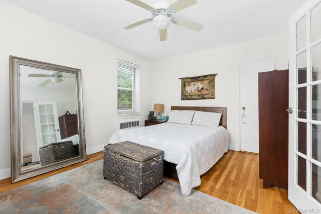 a spacious bedroom with a bed and a large mirror