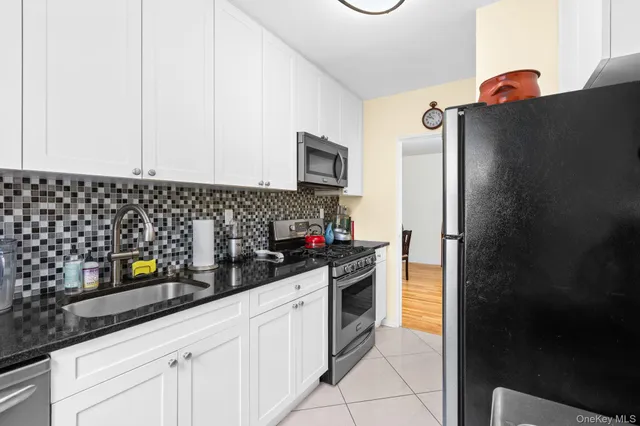 a kitchen with stainless steel appliances a refrigerator sink and stove
