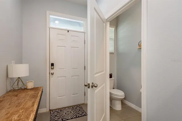 a bathroom with a granite countertop toilet a sink and a mirror