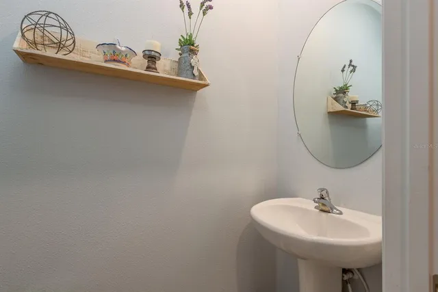 a bathroom with a sink a mirror and vanity