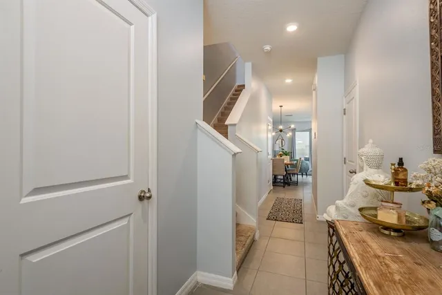 a hallway with a dining table and chairs