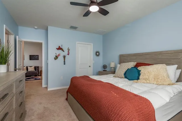 a bedroom with a bed and a chandelier