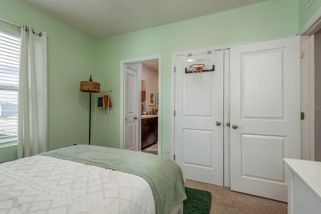 a bedroom with a bed and hallway