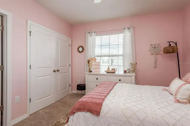 a bedroom with a large bed and a window