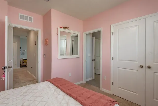 a bedroom with a bed and a view of bathroom