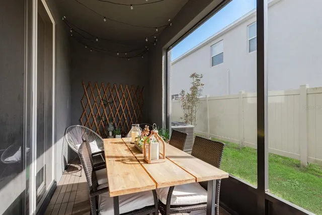 a table and chairs in patio of a house