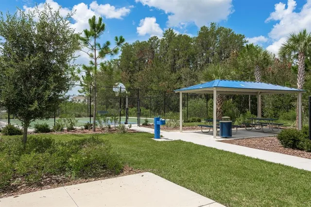 a backyard of a house with table and chairs