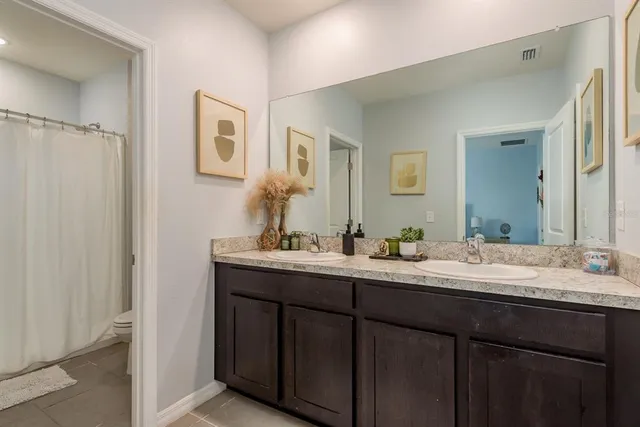 a bathroom with a granite countertop sink mirror and double