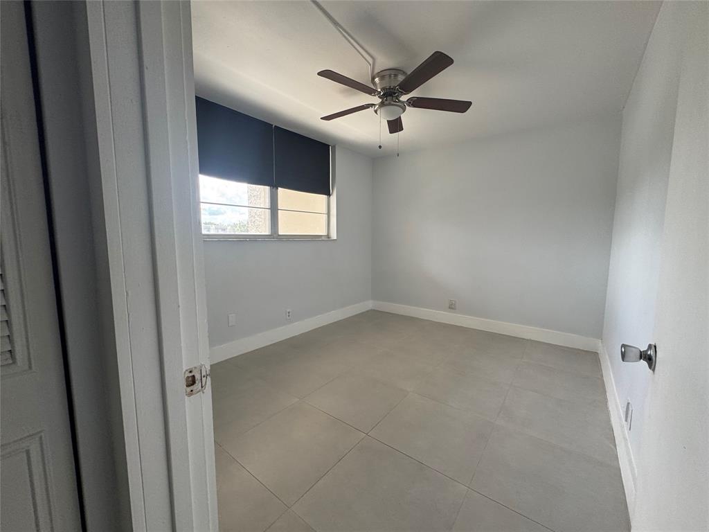 9235 A Lagoon Place, Unit 310 Davie, FL 33324 - Photo 20 of 32 an empty room with a window and a fan