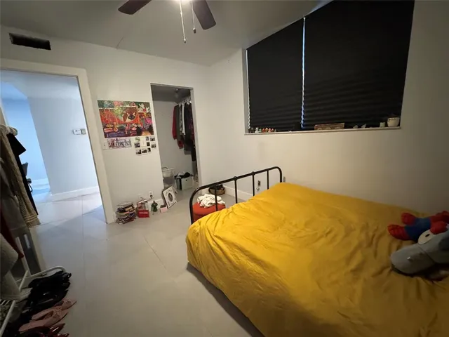 a bedroom with bed and a flat tv screen