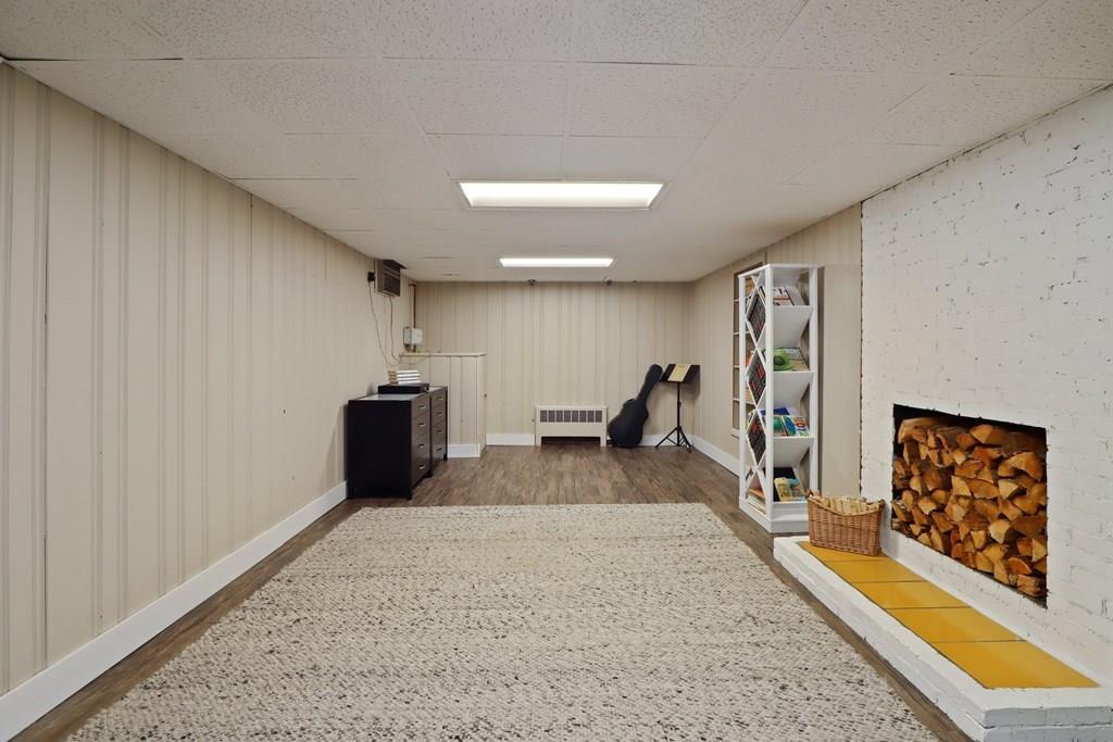 15 Herbert Road Worcester, MA 01602 - Photo 36 of 42 a hallway with a large mirror and a wooden floor