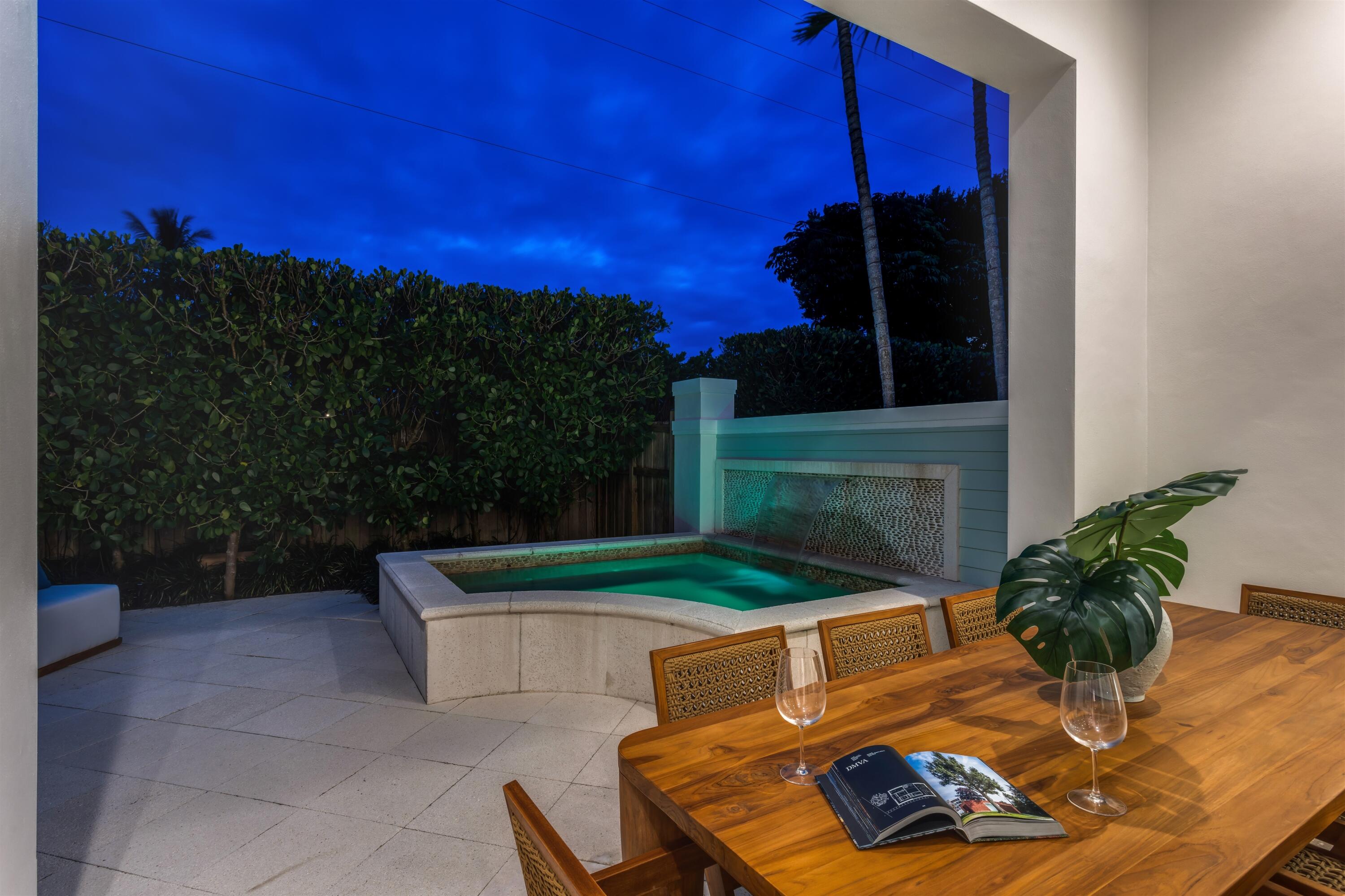 9 Adams Road Ocean Ridge, FL 33435 - Photo 35 of 40 a view of a backyard with table and chairs potted plants and a fire pit