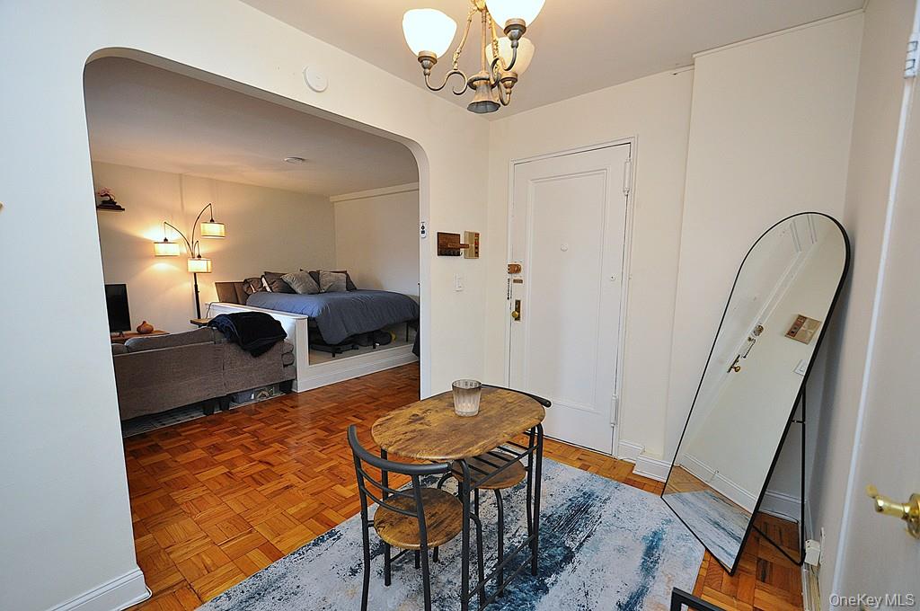 142 Garth Road, Unit 1A Scarsdale, NY 10583 - Photo 14 of 34 a dining room with furniture and wooden floor