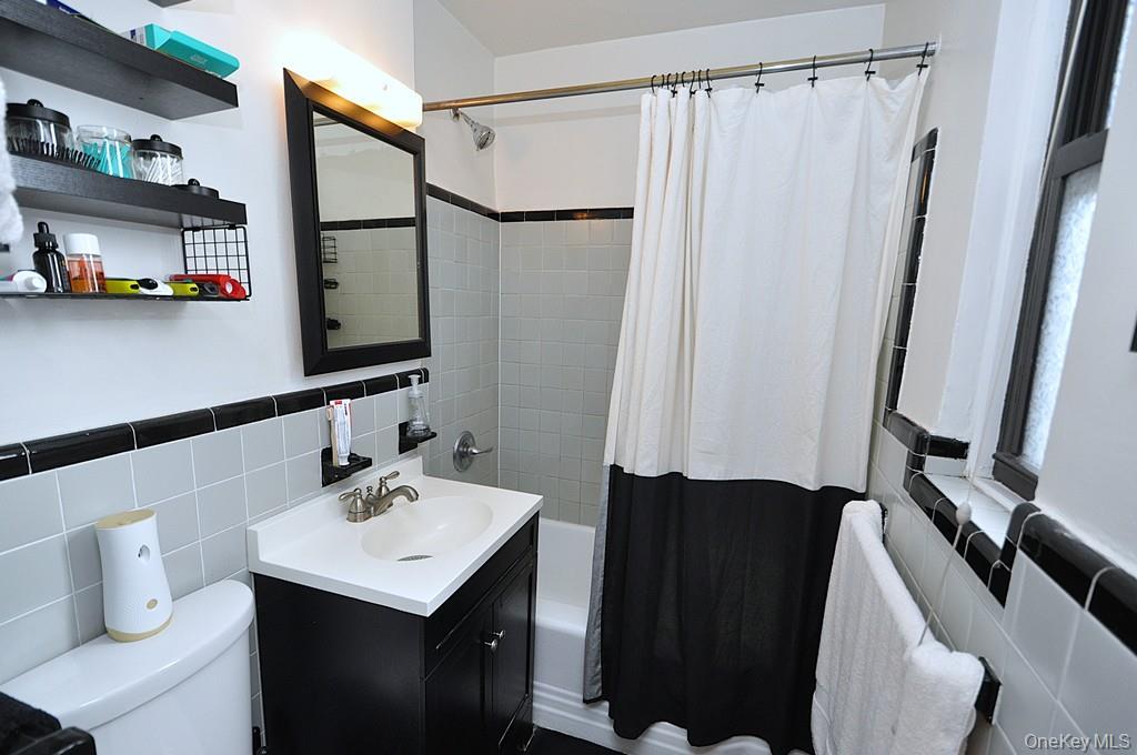 142 Garth Road, Unit 1A Scarsdale, NY 10583 - Photo 18 of 34 a bathroom with a sink a toilet and shower