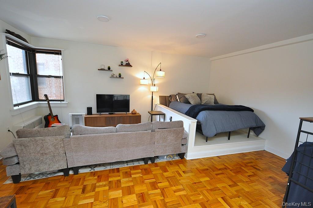 142 Garth Road, Unit 1A Scarsdale, NY 10583 - Photo 3 of 34 a living room with furniture and a flat screen tv