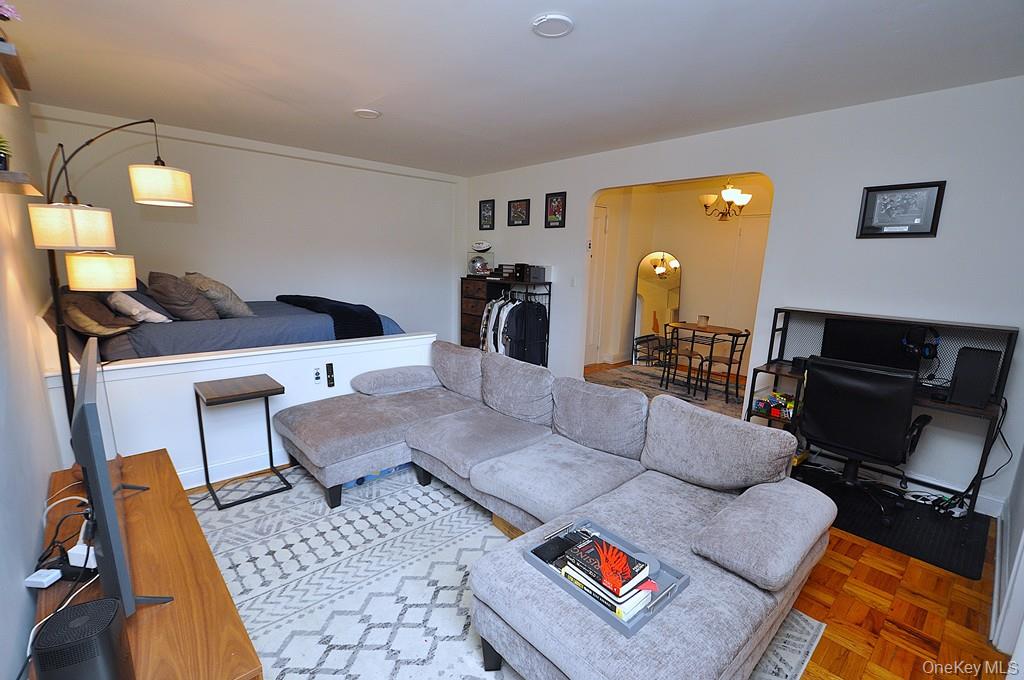 142 Garth Road, Unit 1A Scarsdale, NY 10583 - Photo 4 of 34 a living room with furniture and a flat screen tv