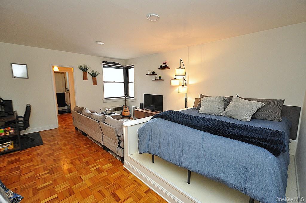 142 Garth Road, Unit 1A Scarsdale, NY 10583 - Photo 6 of 34 a bed room with a bed and a couch