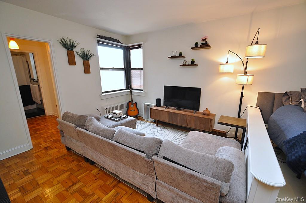 142 Garth Road, Unit 1A Scarsdale, NY 10583 - Photo 7 of 34 a living room with furniture fireplace and a flat screen tv