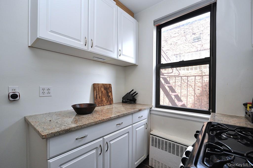 142 Garth Road, Unit 1A Scarsdale, NY 10583 - Photo 8 of 34 a kitchen with a sink and cabinets