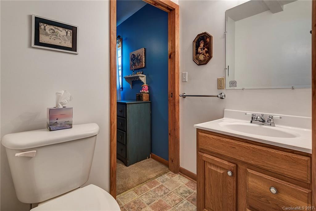 641 Newfound Road Leicester, NC 28748 - Photo 12 of 23 a bathroom with a toilet sink vanity and mirror