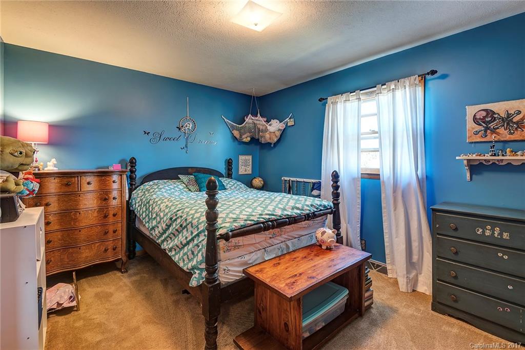 641 Newfound Road Leicester, NC 28748 - Photo 13 of 23 a bedroom with a bed and window
