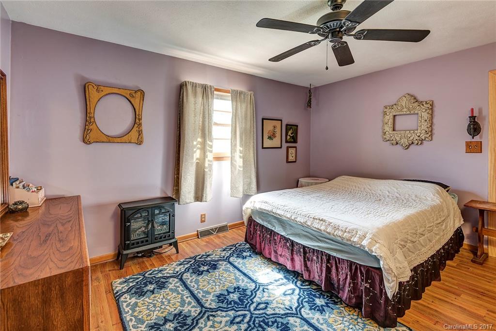 641 Newfound Road Leicester, NC 28748 - Photo 15 of 23 a bedroom with a bed and wooden floor
