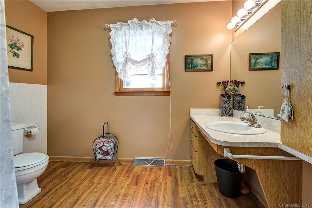 641 Newfound Road Leicester, NC 28748 - Photo 16 of 23 a view of bathroom with a toilet sink and mirror